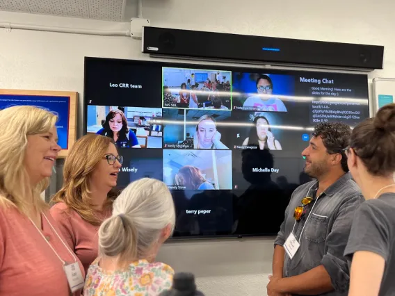 In-person and virtual attendees conversing in a workshop