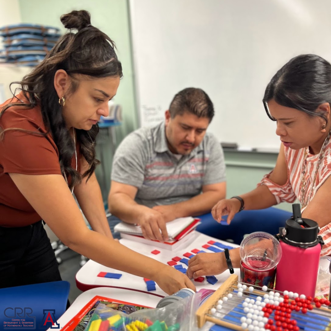 Three teachers collaborating with manipulatives provided to in person attendees