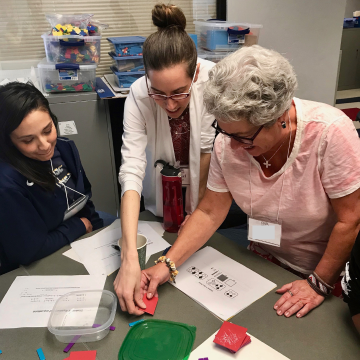 Ariel Beggs assisting teachers with manipulatives